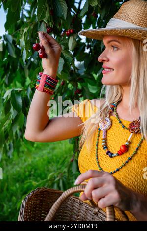 Woman holding hand beneath hanging decorative mobile, smiling at camera ...