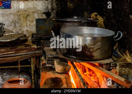 Rustic wood stove preparing food inside the kitchen of a poor house in Brazil Stock Photo