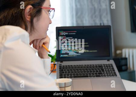 Woman Working And Programming On Computer In Office.woman working on coding on laptop Stock Photo