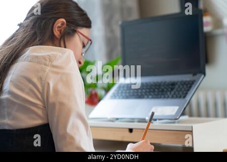 Young Woman Working And Programming On Computer In Office.woman working on coding on laptop Stock Photo