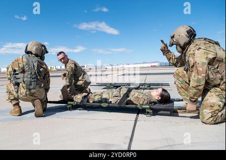 944th Fighter Wing Reserve Citizen Airmen receive instructions from Arizona Army National Guard Soldiers on proper medevac procedures during joint training at Goodyear Phoenix Airport, Goodyear, Ariz., Oct. 19, 2024. The joint medevac training prepares both units for upcoming missions, including Exercise Desert Hammer 25-1 in November. (U.S. Air Force photo by Senior Airman Alexis Orozco) Stock Photo