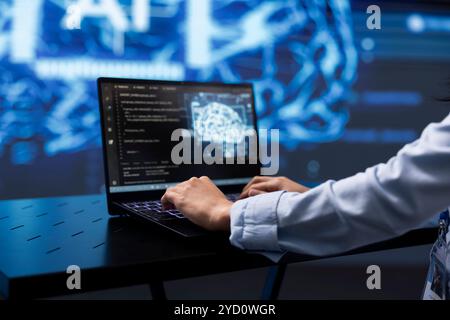 Software developer uses AI cognitive computing to extract information from complex data on laptop. Close up of worker using artificial intelligence on notebook to accelerate complex calculations Stock Photo