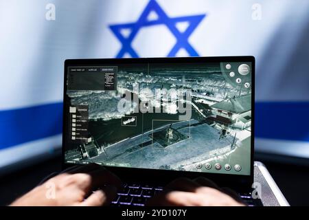 Israeli military personnel working on laptop, analyzing aerial reconnaissance data to come up with warfare winning tactics. Army specialist controlling drone, attacking strategic targets Stock Photo