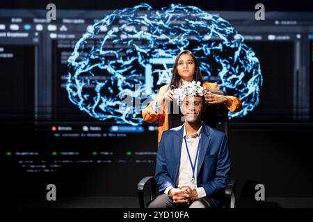 Experts speaking at tech event, explaining impact of neural implants and artificial intelligence technology. Neuroscience researchers present risks and threats associated with AI during experiment Stock Photo