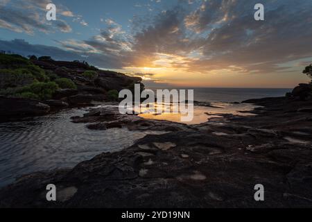 Sunrise and views over the cliffs at Curracurong creek and falls Stock Photo