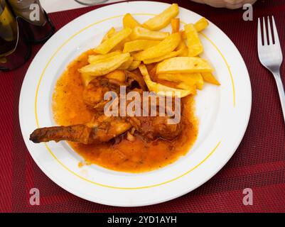 Braised rabbit served with potato garnish Stock Photo