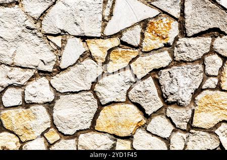 Weathered stone wall as background texture Stock Photo