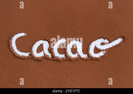 Word "Cacao" written in cocoa powder on a textured surface Stock Photo