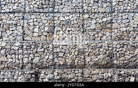 Stone wall with metal grid as background Stock Photo