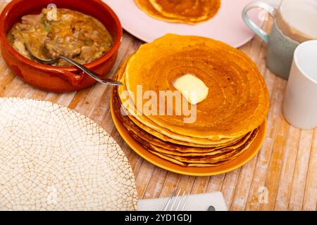 Thin pancakes with butter and mochanka of meat and mushrooms Stock Photo