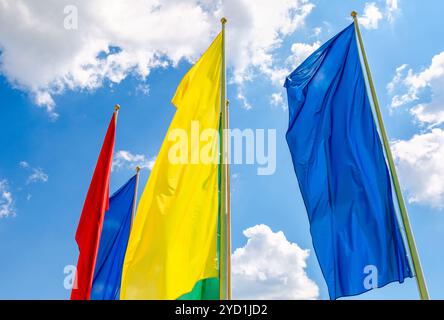 Colorful flags in the wind against the blue sky Stock Photo