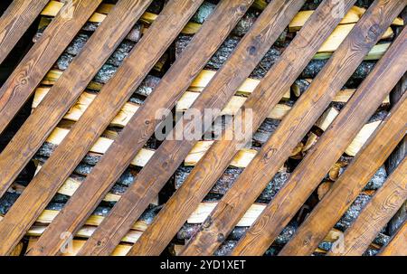 Firewood with diagonal boards as background texture Stock Photo