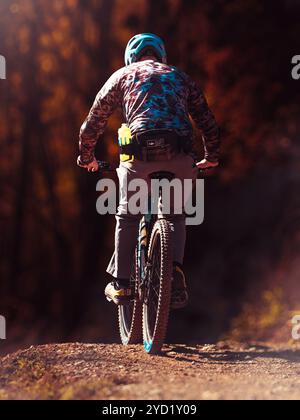 fall bike ride on forest hiking trail in mountains Stock Photo