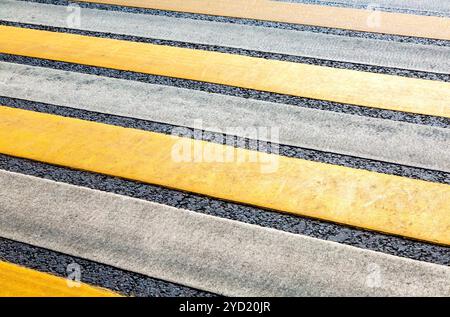 Pedestrian crossing with white and yellow stripes Stock Photo