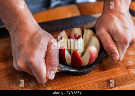 Young man is removing the core of an apple using an apple corer tool Stock Photo