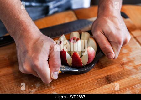 Young man is removing the core of an apple using an apple corer tool Stock Photo