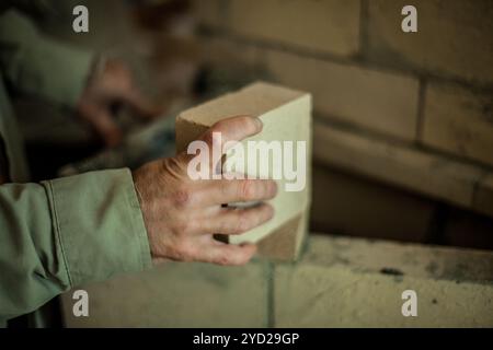 Man working on a brick wall Stock Photo