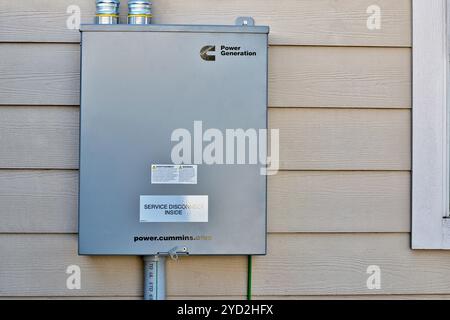 Houston, Texas USA 10-17-2024: Cummins standby generator transfer switch disconnect box wall. Stock Photo