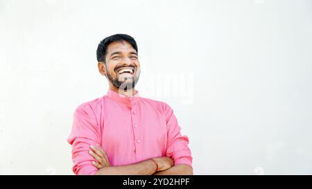 Confident young indian man wearing ethical dress standing cross arms against white background, Smiling handsome asian male with positive expression po Stock Photo