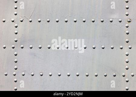 Metal surface with rivets as background Stock Photo