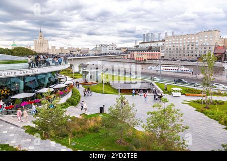 Moscow, Russia - July 8, 2019: View of the floating bridge over which people walk in Zaryadye park. Pleasure boats sail under floating bridge above ri Stock Photo