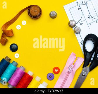 Layout sewing. needlework, craft, sewing and tailoring concept - box with thread spools and buttons on the table. The concept of Stock Photo