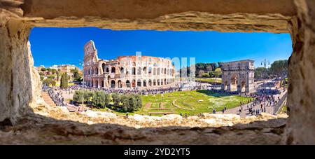 Rome. Colosseum of Rome and Arch of Constantine scenic panoramic view through stone window Stock Photo