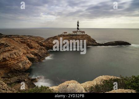 Long exposure view of the Cap de Cala Figuera lighthouse under an overcast sky Stock Photo