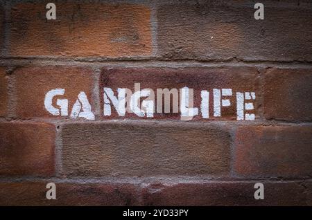 Urban Gang Life Stencil Graffiti On A Red Brick Wall Stock Photo