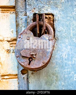 Rusty padlock on an old metal door Stock Photo