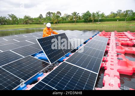 Professional Engineer Service Floating Solar Panel. Worker Maintenance Cleaning Replacing Solar Panel. Solar photovoltaic panel system in Industry lak Stock Photo