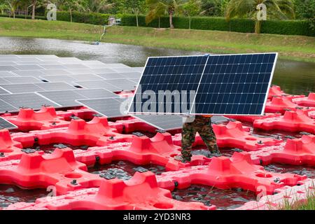 Professional Engineer Service Floating Solar Panel. Worker Maintenance Cleaning Replacing Solar Panel. Solar photovoltaic panel system in Industry lak Stock Photo