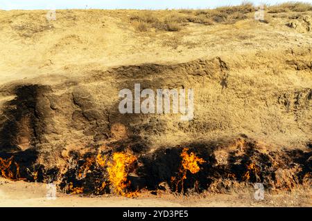 Yanar Dagh (Yanardag) ,  'burning mountain'  is a natural gas fire which blazes continuously on a hillside on the Absheron Peninsula on the Caspian Se Stock Photo