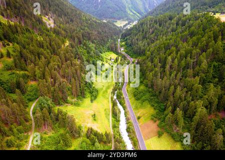 Stelvio pass road and river canyon in Dolomites Alps aerial view Stock Photo