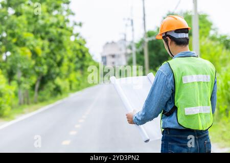 Engineer male road construction working with blueprint. finished asphalt road worker inspector check quality. Stock Photo