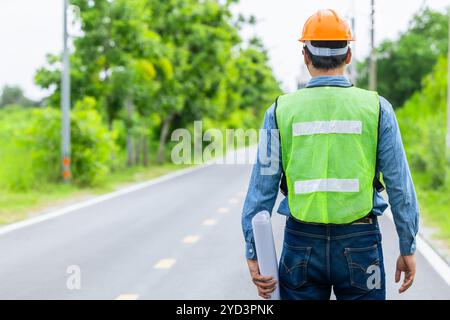 Engineer male road construction working with blueprint. finished asphalt road worker inspector check quality. Stock Photo