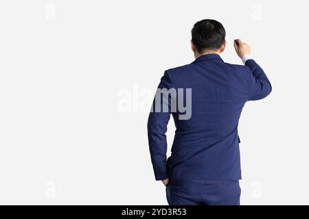 Man in formal suit model acting writing whiteboard view form back isolated on white background. Stock Photo