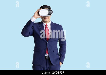 businessman using visual VR technology isolated on blue background, business people using modern hologram technology device. Stock Photo