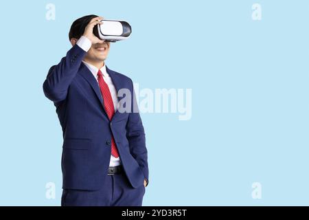 businessman using visual VR technology isolated on blue background, business people using modern hologram technology device. Stock Photo