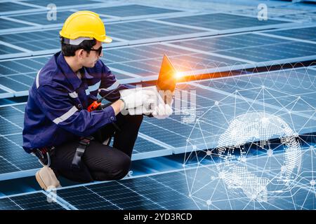 Engineer working with solar panel photovoltaic energy system overlay with digital graphic decoration for modern power management background Stock Photo