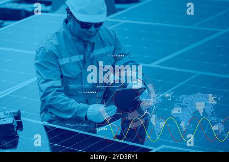 Engineer working with solar panel photovoltaic energy system overlay with digital graphic decoration for modern power management background Stock Photo