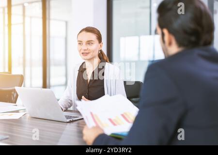 Business women talking with boss in office room, Marketing secretary work on the table with manager happy present information to deciding Stock Photo