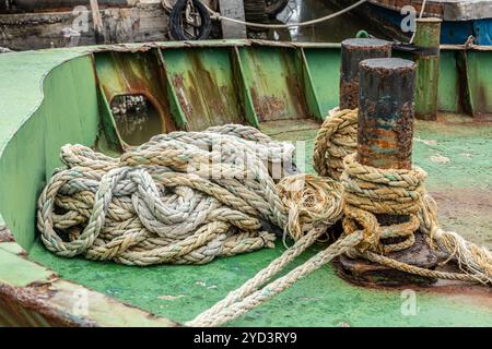 Boat rope, Mooring Line heavy duty old grunge used weathered for secure parking the boat at pier dock. Stock Photo