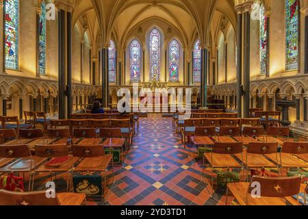 The historic Lady Chapel at St. Patrick's Cathedral, Dublin, showcases detailed gothic design with vibrant stained-glass windows and elegant columns Stock Photo