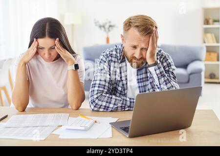 Young upset couple counting overspent budget having financial problems Stock Photo
