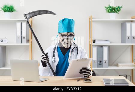 Doctor in scary Death Reaper costume sitting at table and reading medical documents Stock Photo