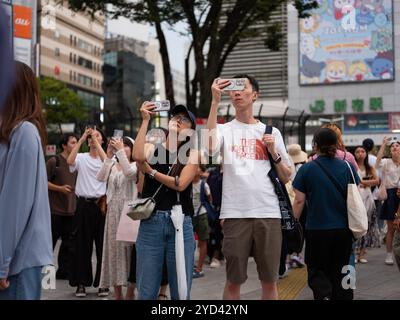 People taking photographs of the Shinjuku lights in, Tokyo, Japan. Stock Photo