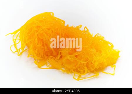 Close-up of delicate golden yellow egg yolk threads of Foi thong, a popular Thai sweet dessert of Portugese origin, isolated on white Stock Photo