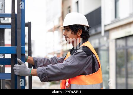 young technician  male with helmet and safety vest  working Stock Photo
