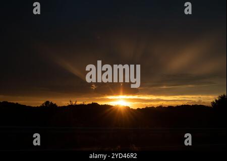 Dramatic sunset with dark sky and dark foreground Stock Photo